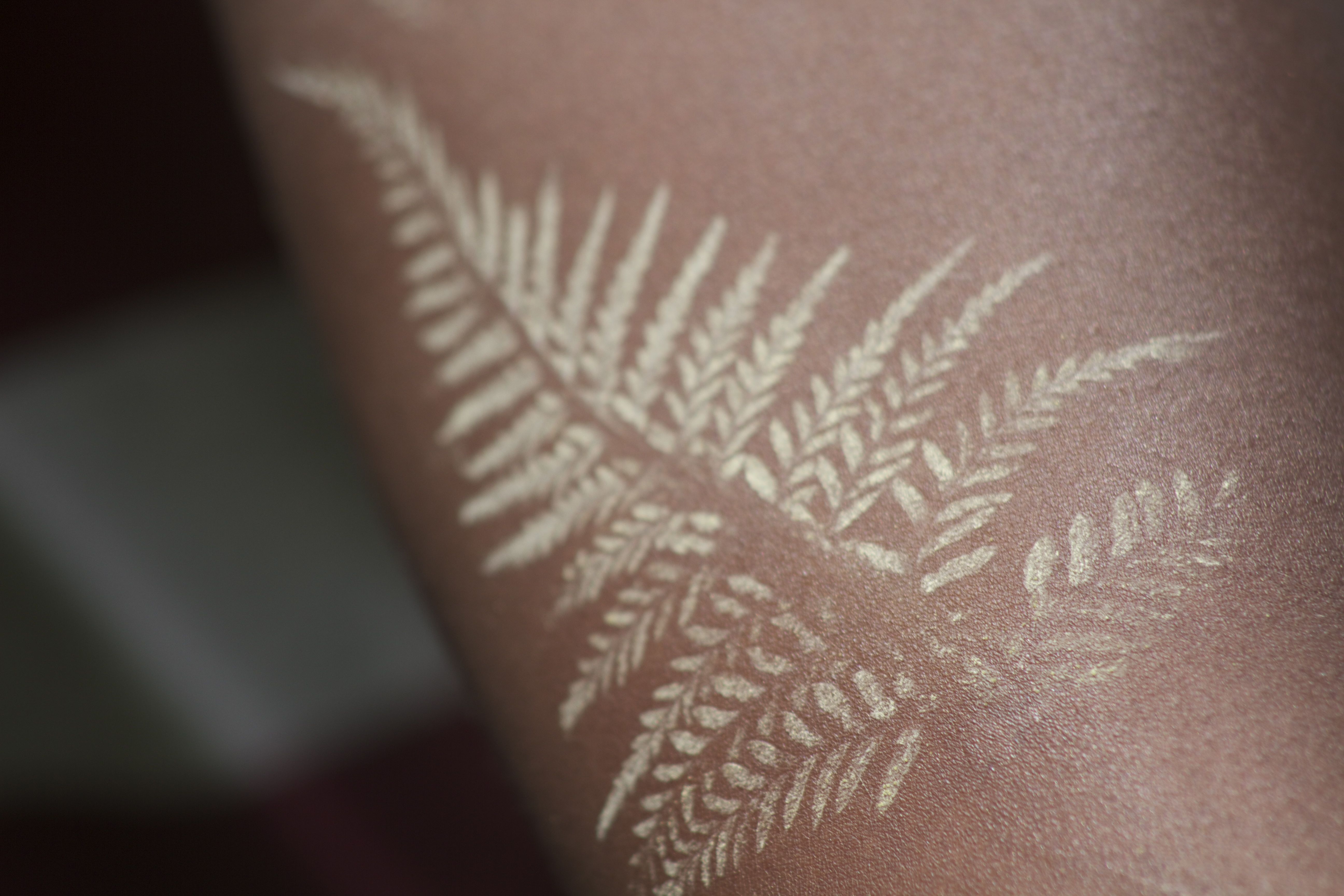 Several leaves white ink tattoo
